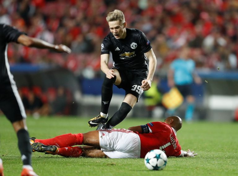 Benfica's Luisao fouls Manchester United's Scott McTominay leading to a second yellow card and red card.