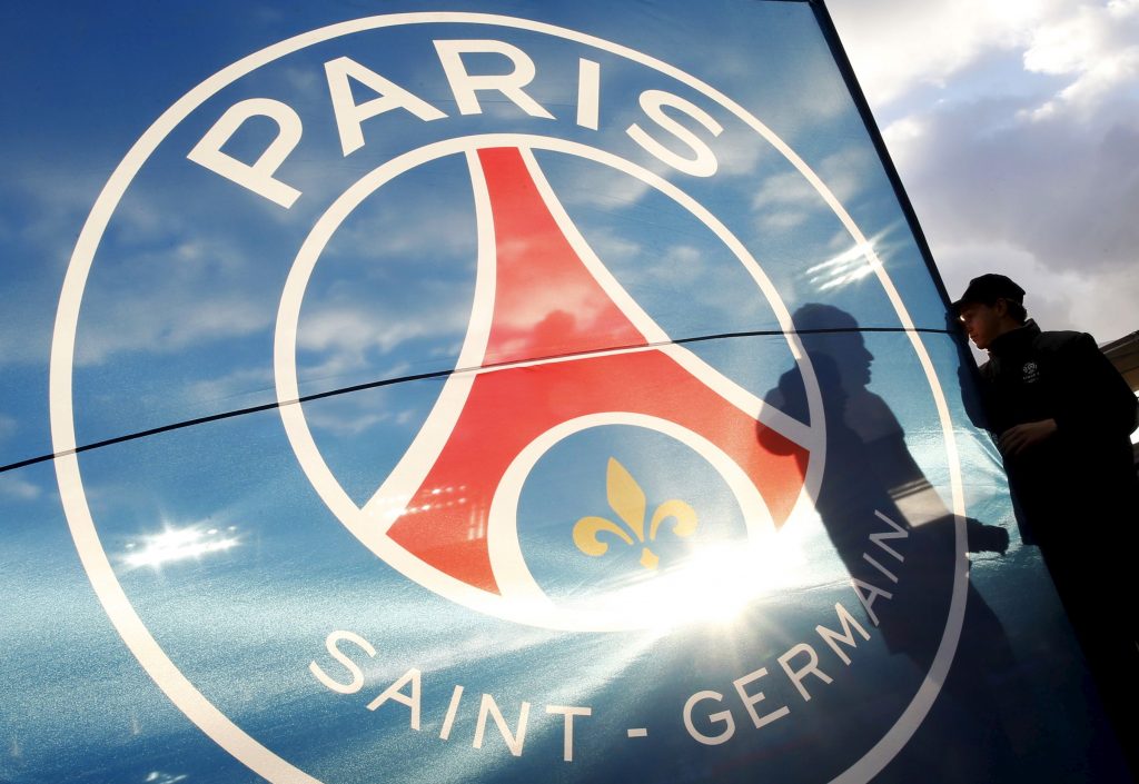 Municipal Stadium's staff hold PSG's flag just before the French Ligue 1 soccer match.