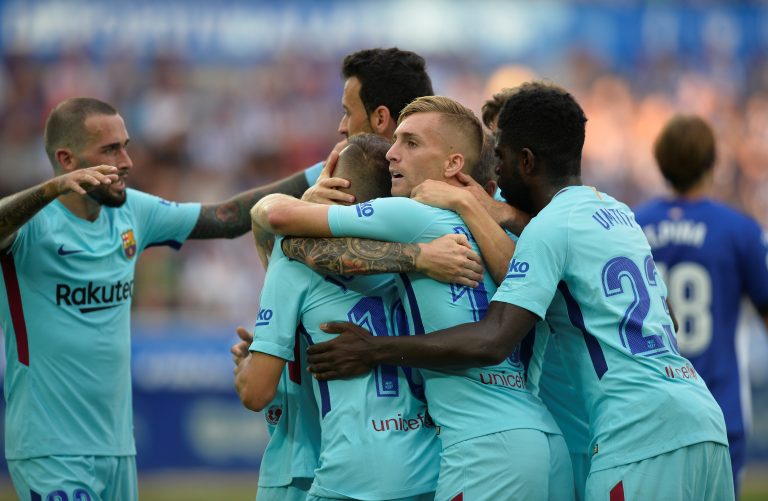 Barcelonas Lionel Messi celebrates scoring their first goal with Samuel Umtiti and team mates.
