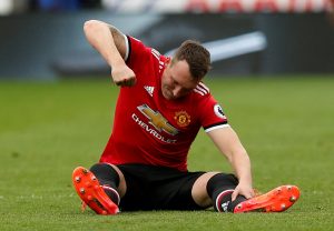 Phil Jones looks dejected after sustaining an injury.