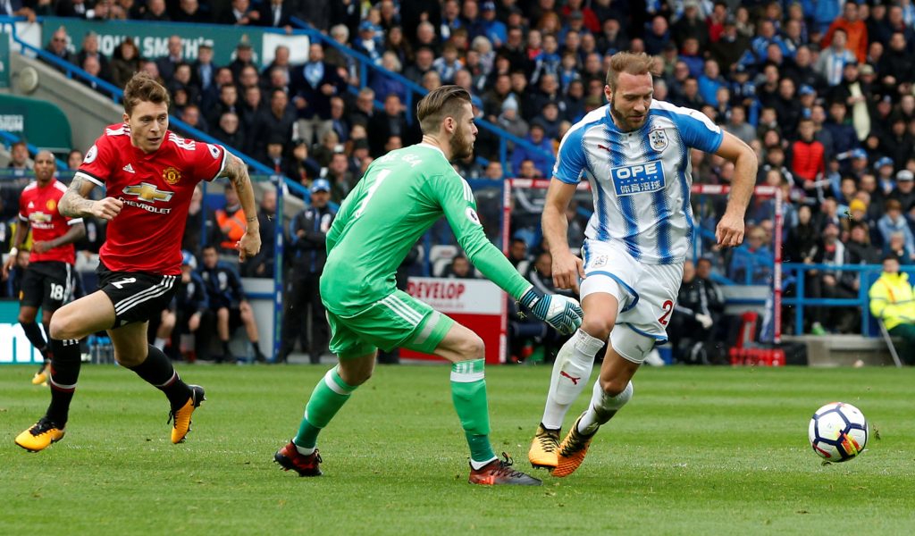 Huddersfield Towns Laurent Depoitre goes round David De Gea before scoring their second goal.