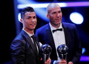 Cristiano Ronaldo celebrates after winning The Best FIFA Mens Player Award with Zinedine Zidane.
