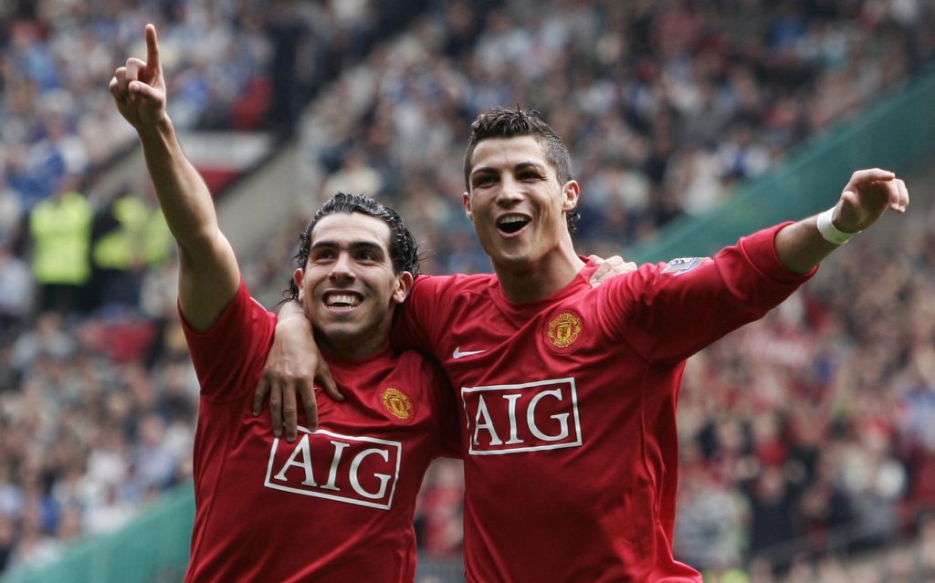 Carlos Tevez (L) celebrates with Cristiano Ronaldo after scoring against Wigan Athletic.