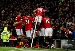 Ashley Young celebrates scoring with teammates.