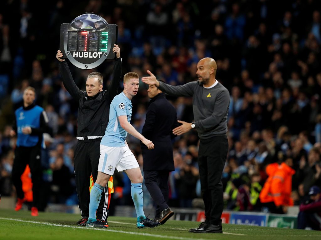 Man City's Kevin De Bruyne walks off to be substituted as manager Pep Guardiola looks on.
