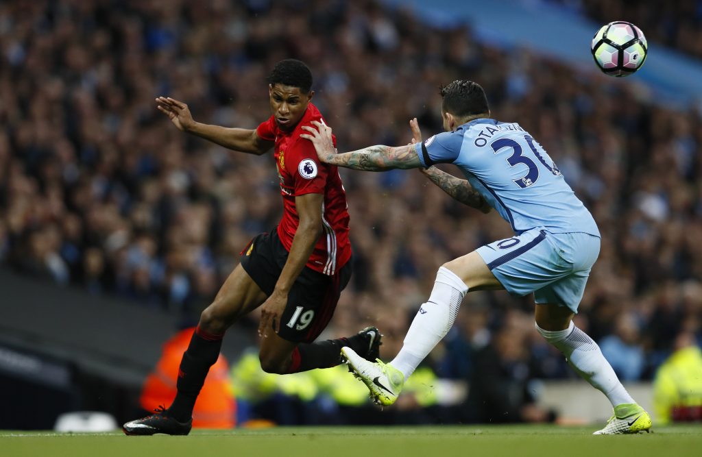 Nicolas Otamendi in action with Marcus Rashford.