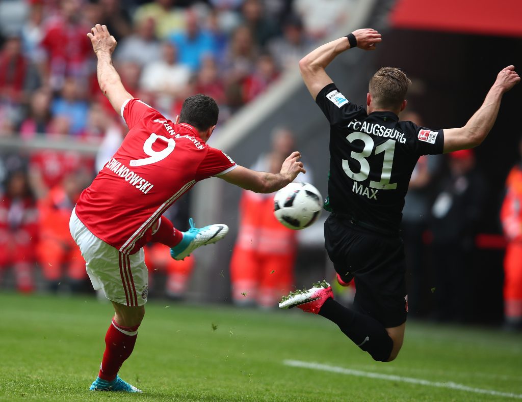 Bayern Munich's Robert Lewandowski scores a goal past Augsburg's Philipp Max.