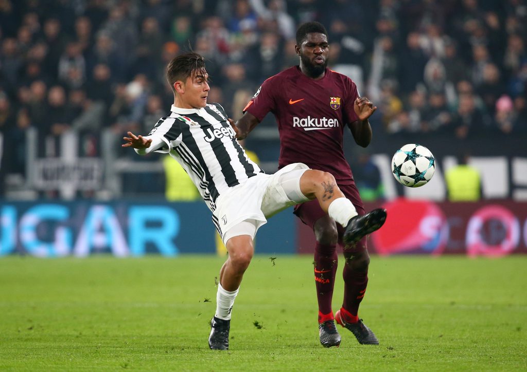 Juventus Paulo Dybala in action with Barcelonas Samuel Umtiti.