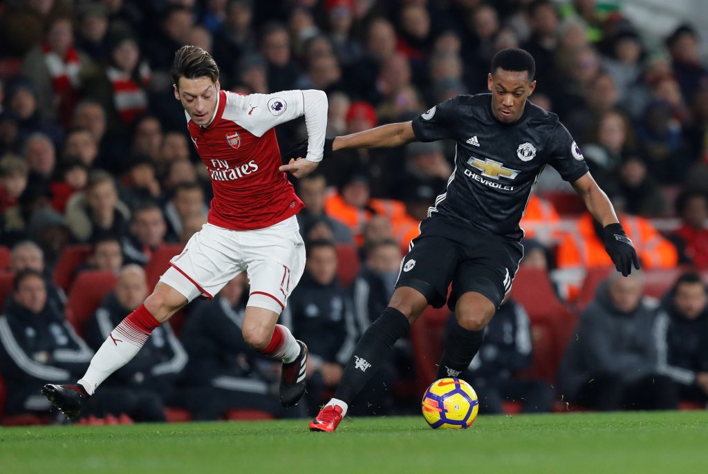 Arsenal's Mesut Ozil in action with Manchester United's Anthony Martial.