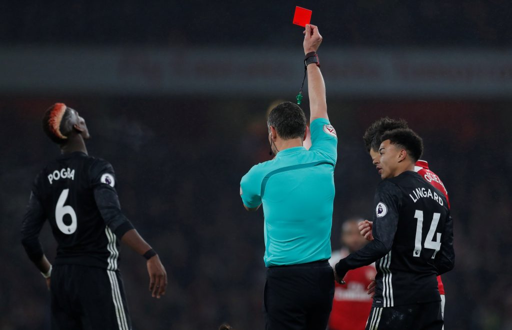 Paul Pogba is shown a red card by referee Andre Marriner.