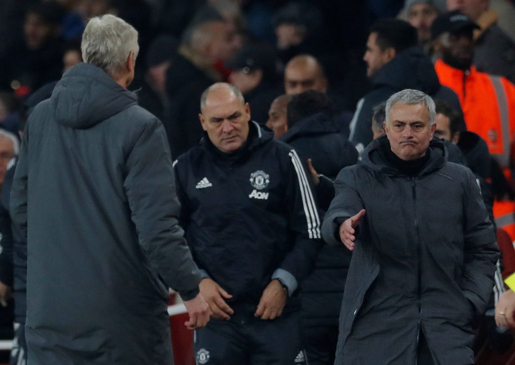 Jose Mourinho gestures to shake hands with Arsene Wenger after the match.