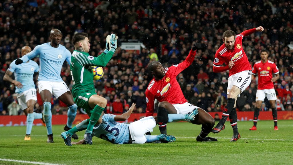 Juan Mata has a shot saved by Man City's Ederson.