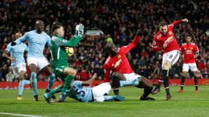 Juan Mata has a shot saved by Man City's Ederson.