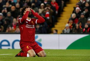 Liverpool's Mohamed Salah reacts after missing a header.
