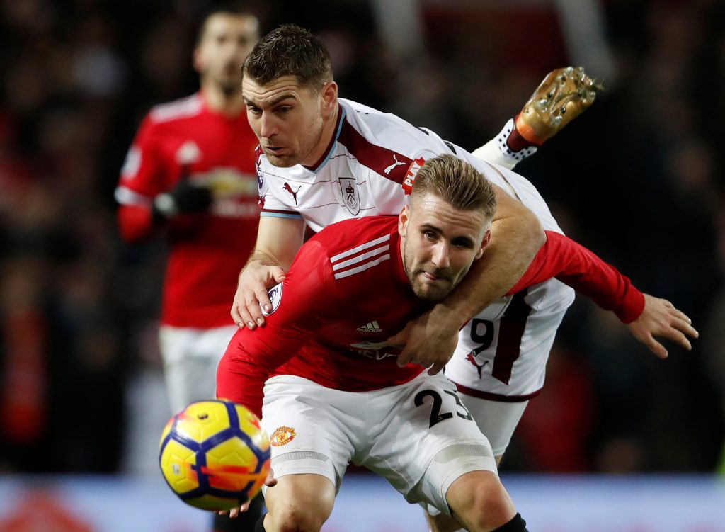 Burnley's Sam Vokes in action with Luke Shaw.