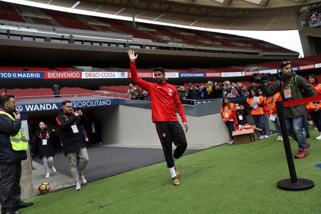Atletico Madrid's soccer player Diego Costa waves to fans.