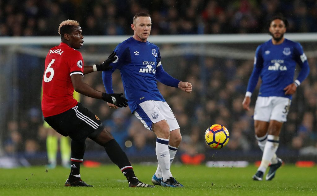 Everton's Wayne Rooney in action with Paul Pogba.