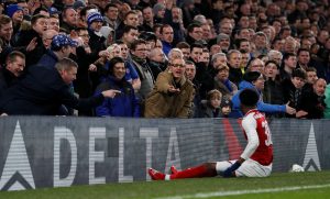 Arsenal's Ainsley Maitland-Niles as Chelsea fans gesture.