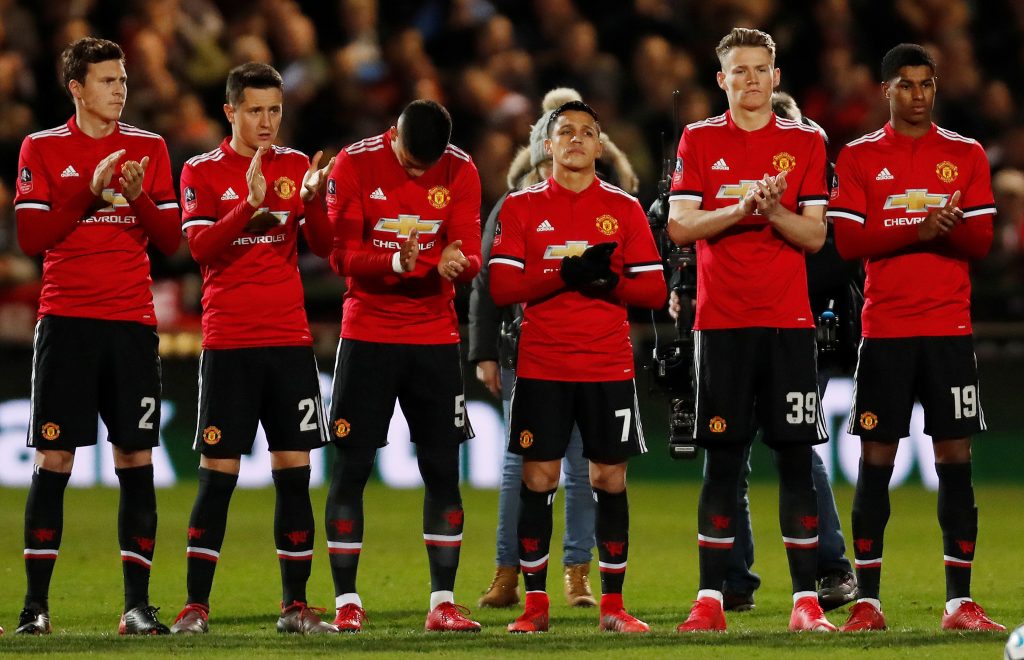 Manchester United players observe a minute's applause in memory of Jimmy Armfield before the match.