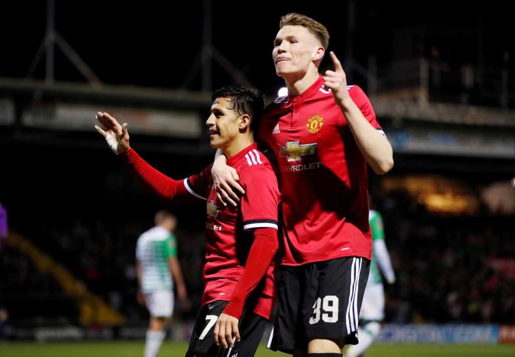 Manchester Uniteds Alexis Sanchez celebrates their second goal with Scott McTominay.