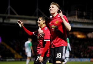 Manchester Uniteds Alexis Sanchez celebrates their second goal with Scott McTominay.