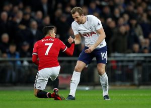 Tottenham's Harry Kane helps up Manchester Uniteds Alexis Sanchez.