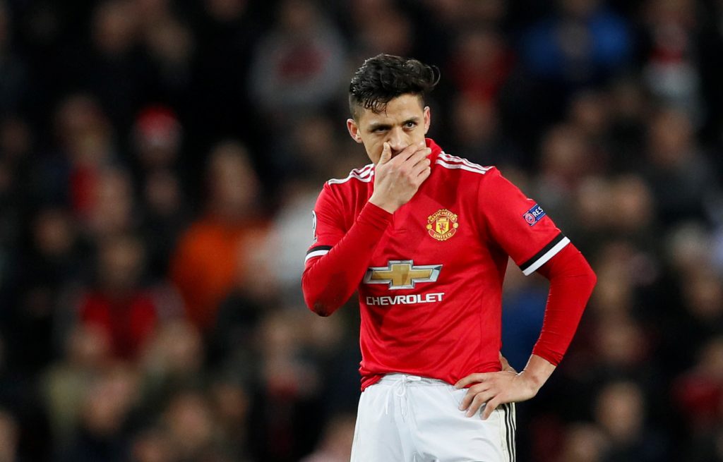 Alexis Sanchez looks dejected.