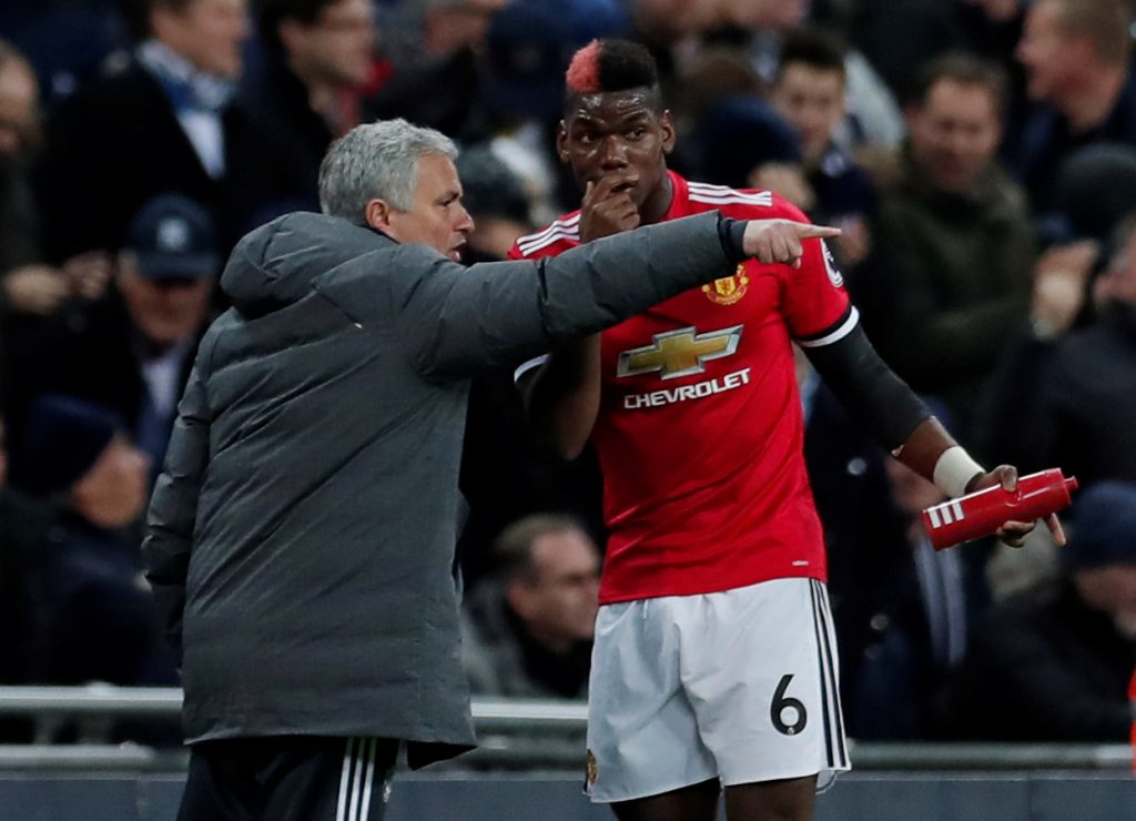 Manchester United's Paul Pogba receives instructions from manager Jose Mourinho.