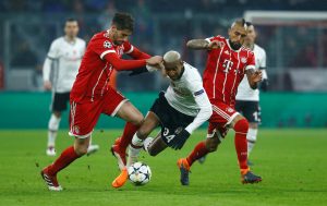 Besiktas' Anderson Talisca in action with Bayern Munich's Javi Martinez and Arturo Vidal.