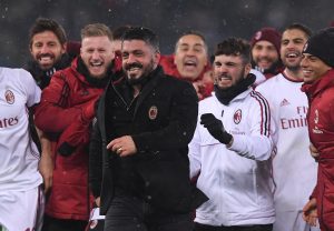 AC Milan coach Gennaro Gattuso and players celebrate after winning the penalty shootout.