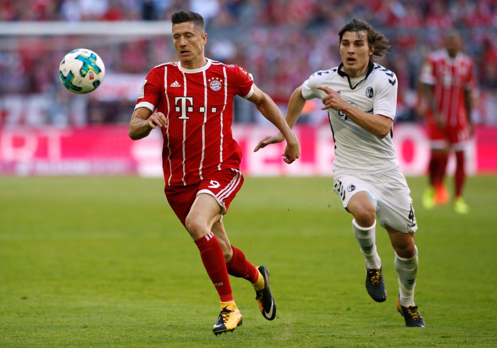 Bayern Munich's Robert Lewandowski in action with SC Freiburgs Caglar Soyuncu.