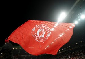 A Manchester United flag is waved before the match.