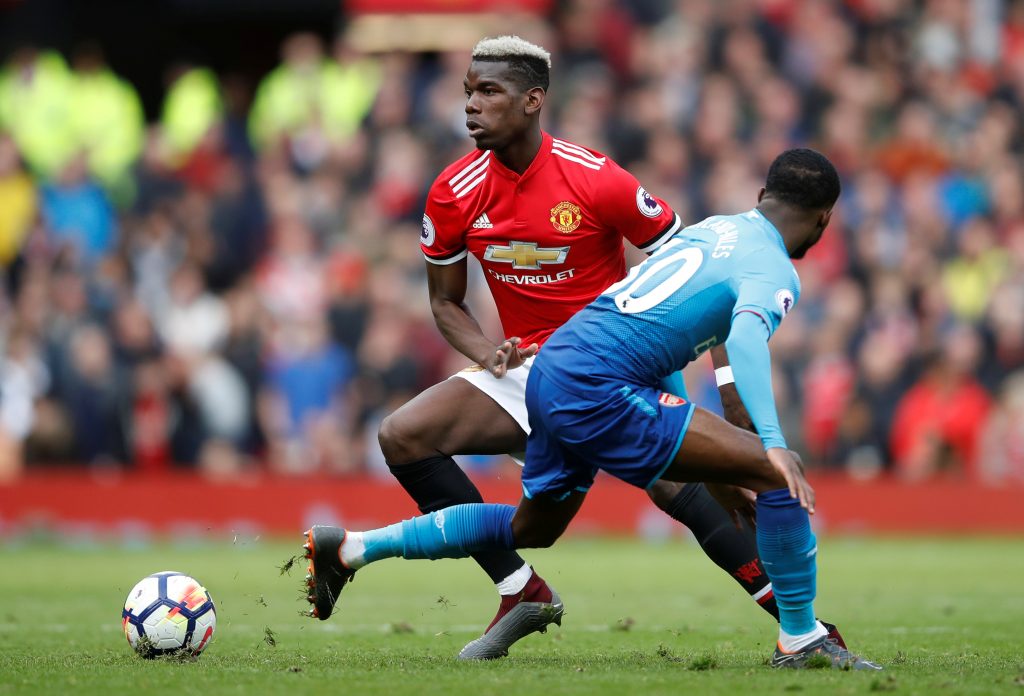Paul Pogba in action with Arsenal's Ainsley Maitland-Niles.