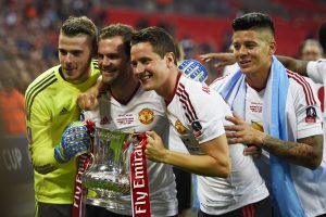 David De Gea, Juan Mata, Ander Herrera and Marcos Rojo celebrate with the trophy after winning the FA Cup.