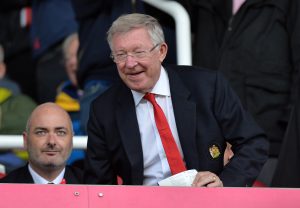 Sir Alex Ferguson watches the match from the stands.