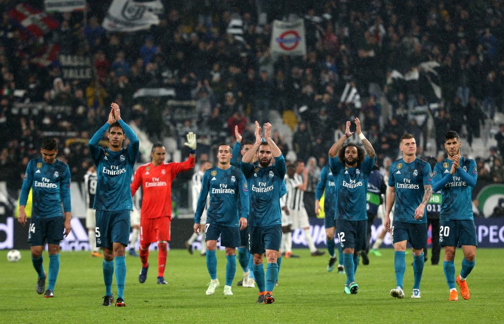 Real Madrid players applaud fans as they celebrate after the match.