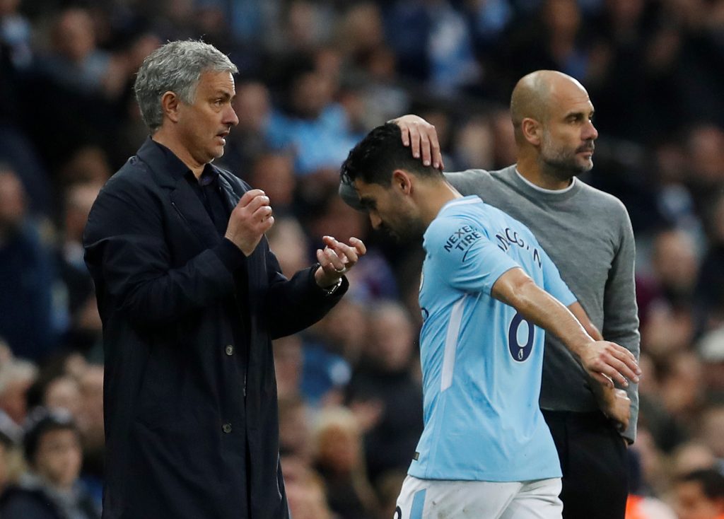 Ilkay Gundogan is substituted off as managers Pep Guardiola and Jose Mourinho look on.