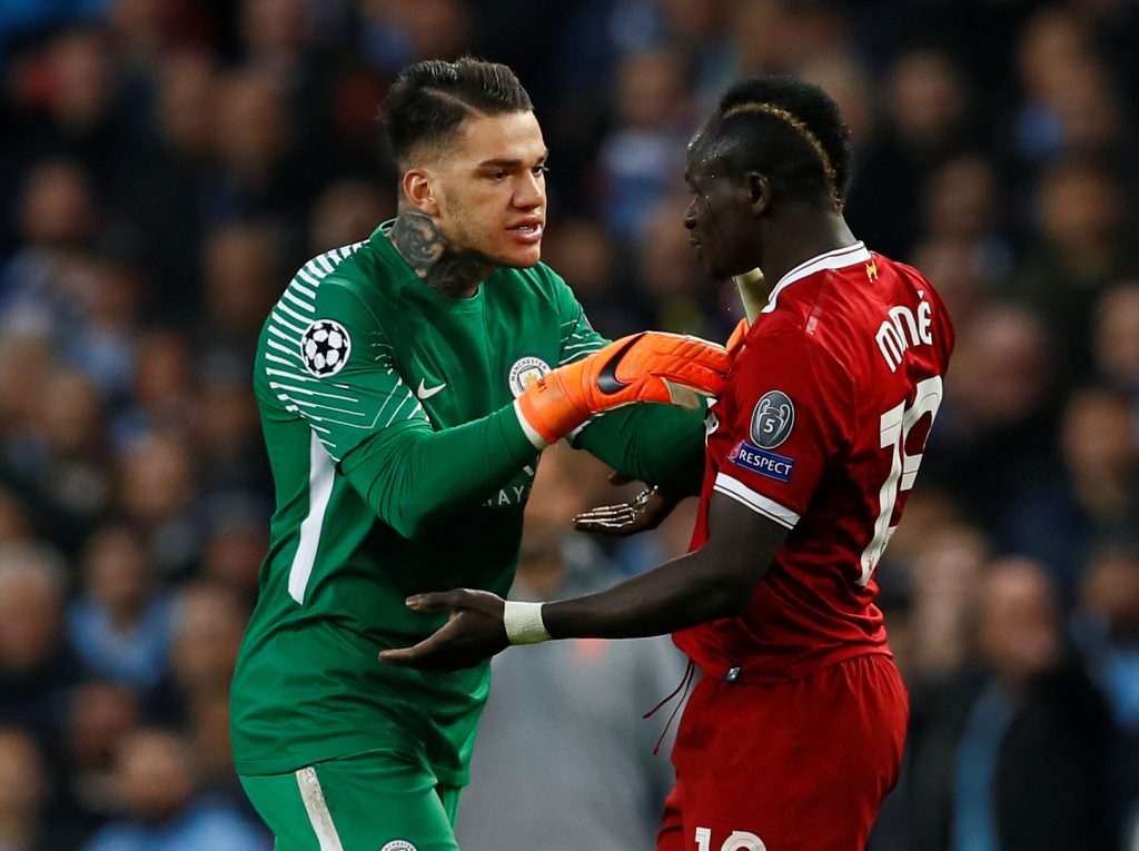 Man City's Ederson clashes with Liverpool's Sadio Mane.
