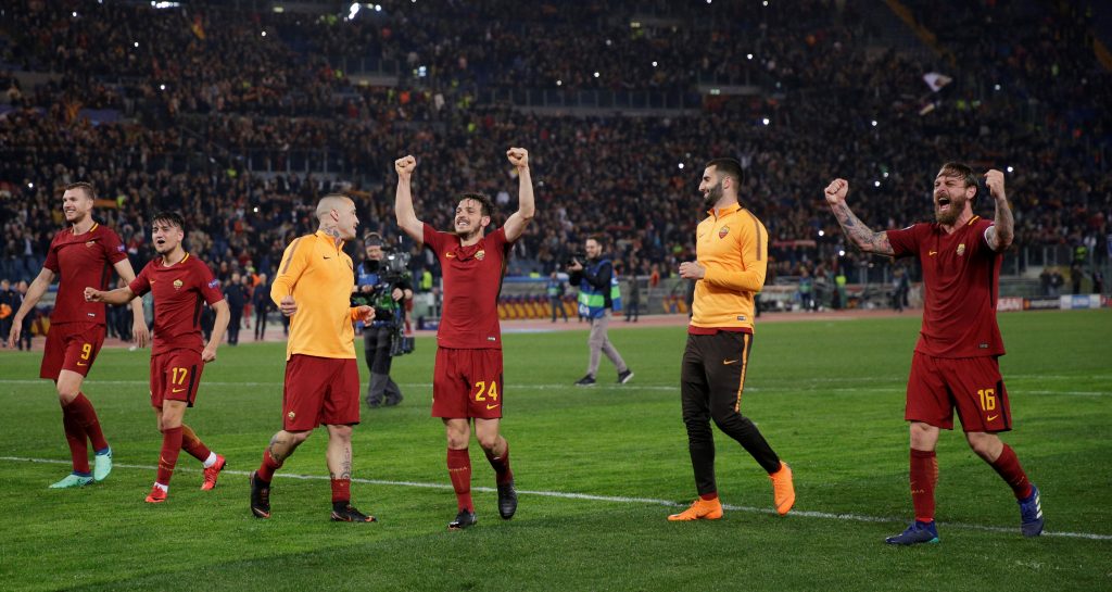 Roma's Alessandro Florenzi, Daniele De Rossi and team mates celebrate after the match.