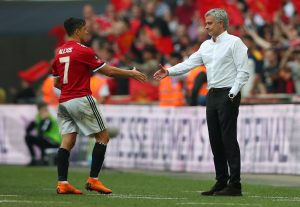 Alexis Sanchez shakes hands with manager Jose Mourinho after being substituted off.