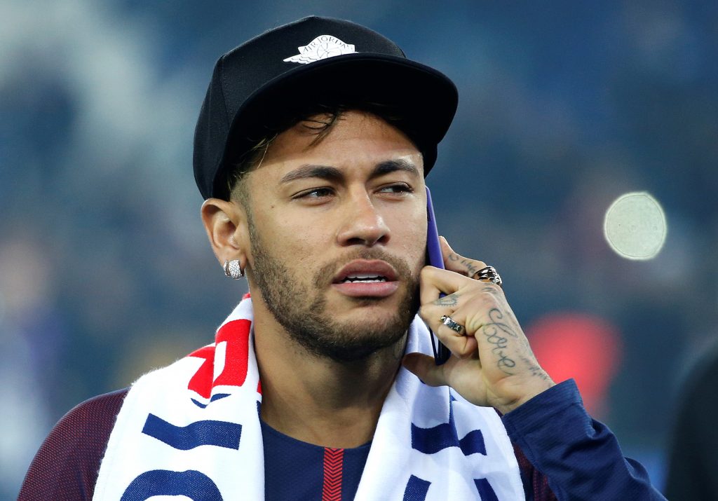 Paris Saint-Germain's Neymar on the phone as he celebrates winning Ligue 1.