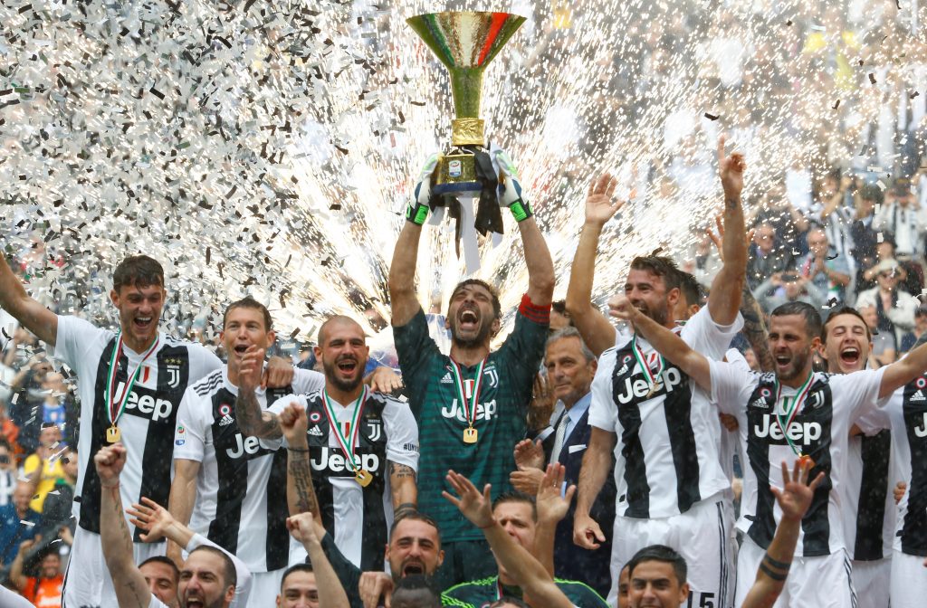 Juventus' Gianluigi Buffon lifts the trophy as the Juventus players celebrate winning the league.