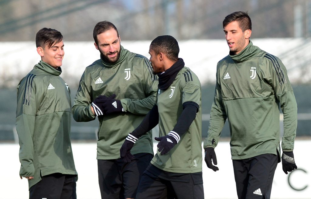 Juventus Douglas Costa, Gonzalo Higuain (2nd L) and Paulo Dybala (L) during training.