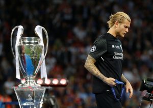 Liverpool's Loris Karius walks past the trophy with his medal after the match.