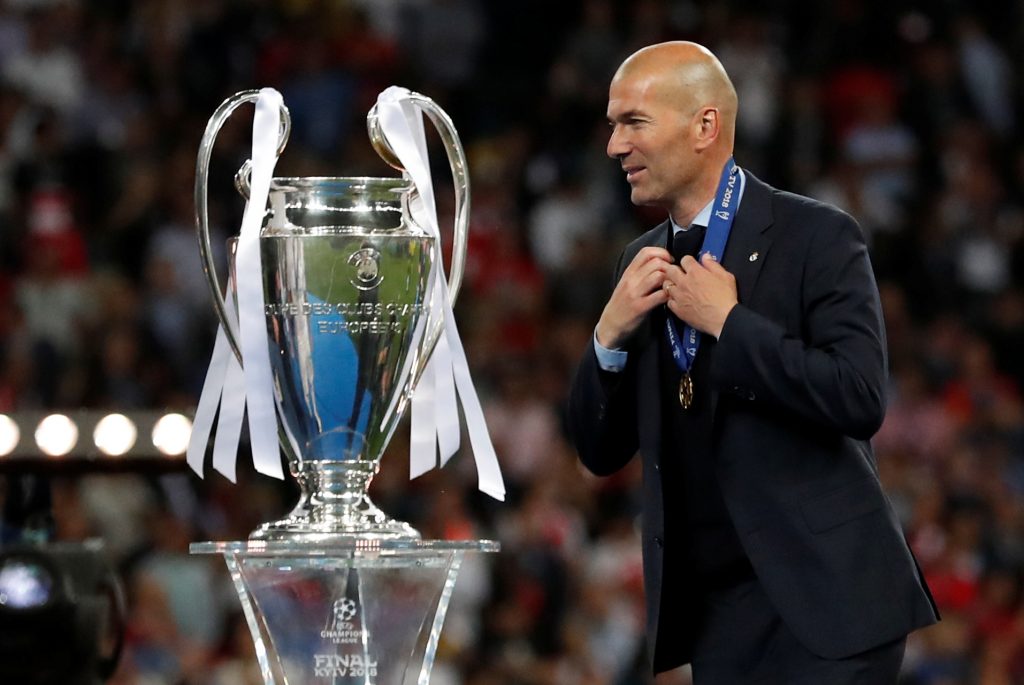 Real Madrid coach Zinedine Zidane walks past the trophy during the medal ceremony after winning the Champions League.