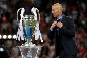 Real Madrid coach Zinedine Zidane walks past the trophy during the medal ceremony after winning the Champions League.