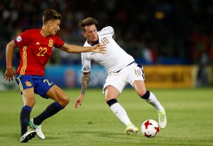 Italy's Federico Chiesa in action with Spain's Marcos Llorente.