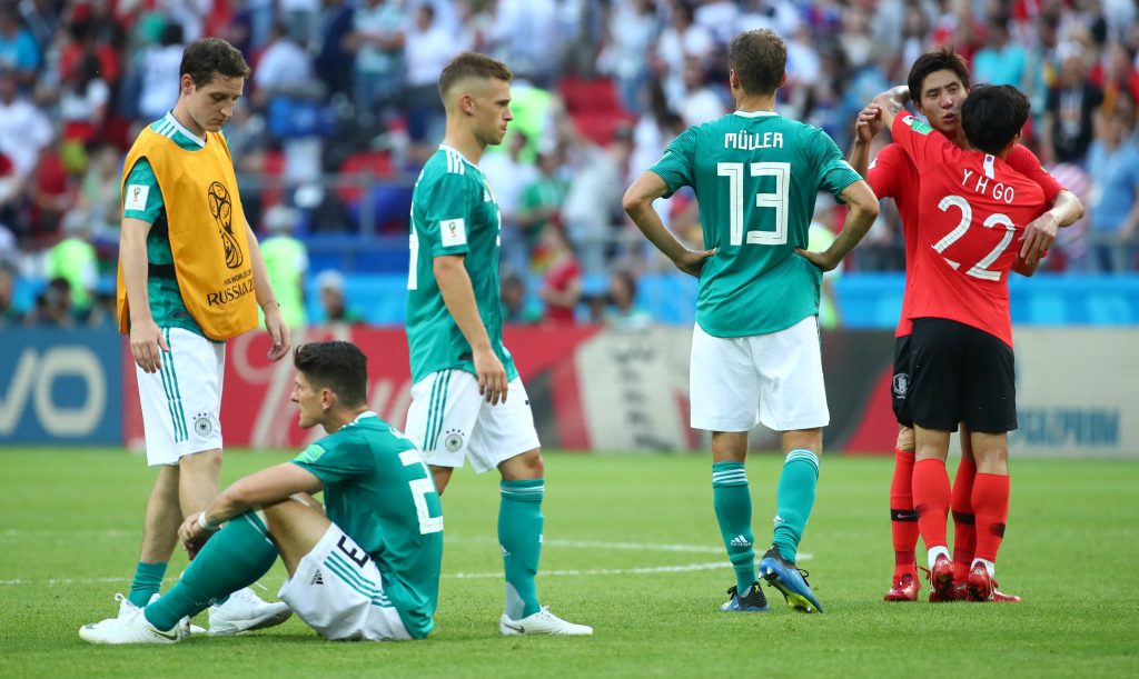 Germany players look dejected as South Korea players celebrate after the match.