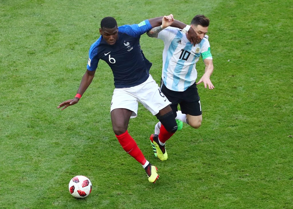 France's Paul Pogba in action with Argentina's Lionel Messi.