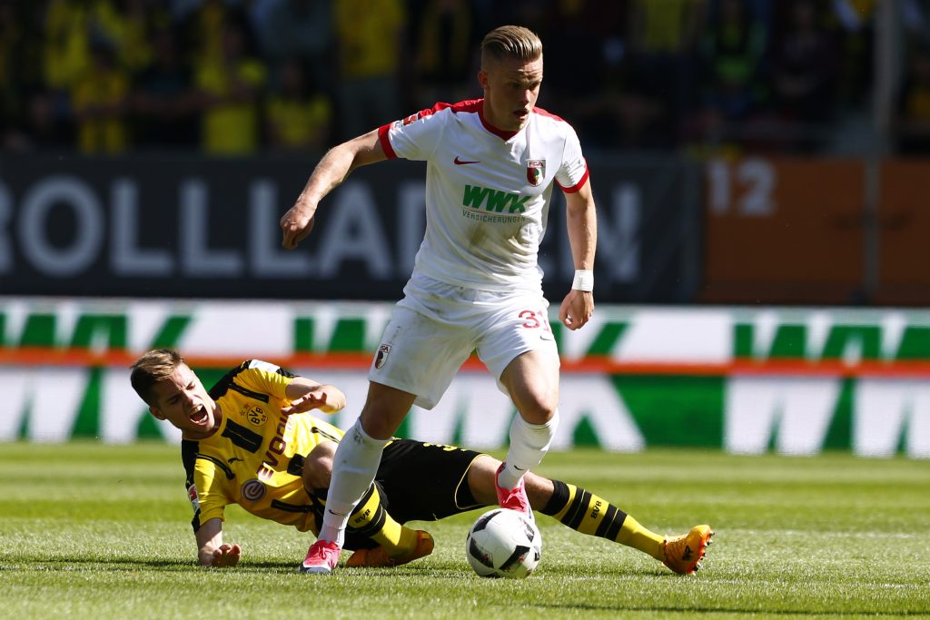 Augsburg's Philipp Max in action with Borussia Dortmund's Julian Weigl.